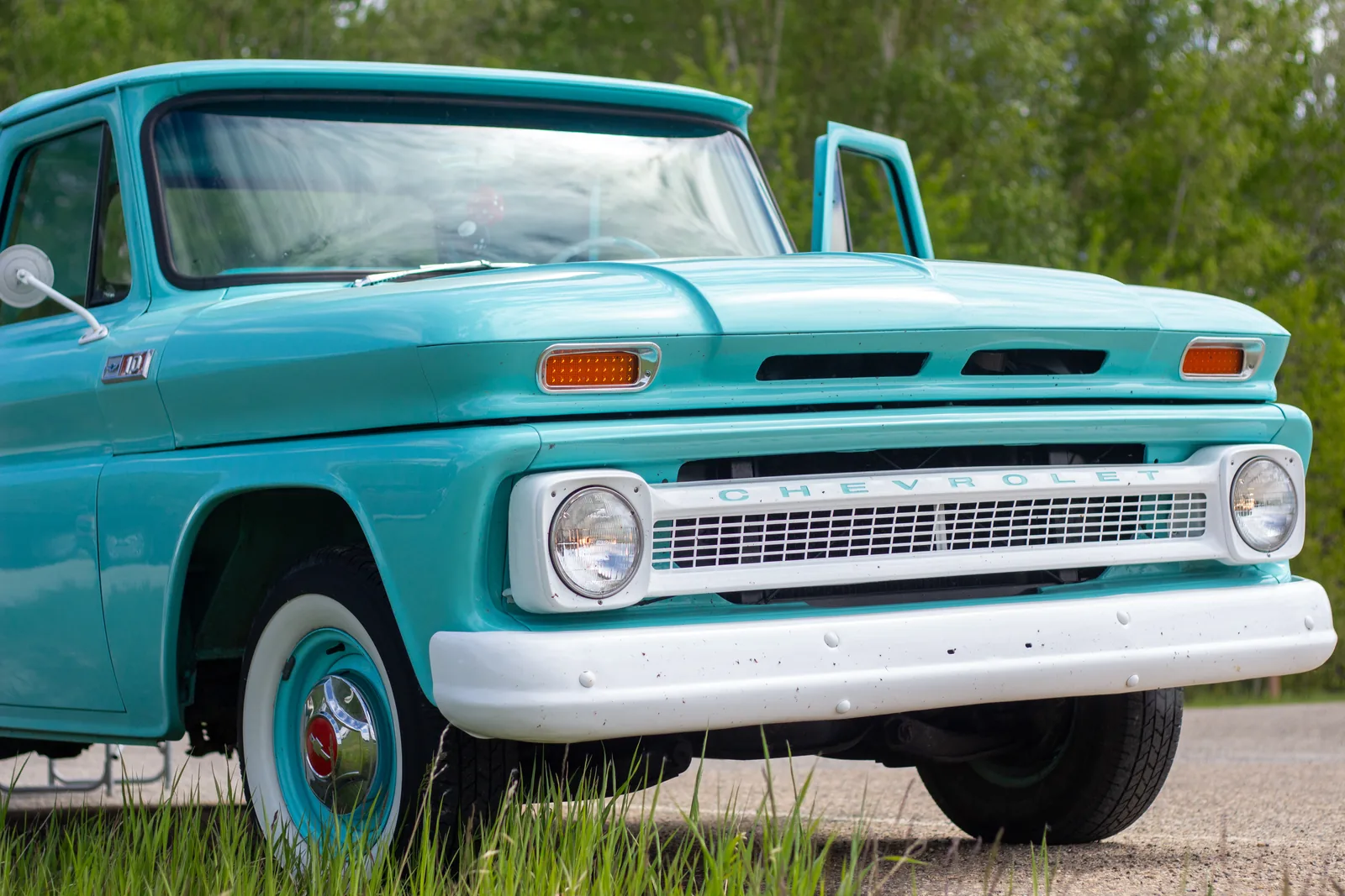 A turquoise vintage Chevy pickup at the car show